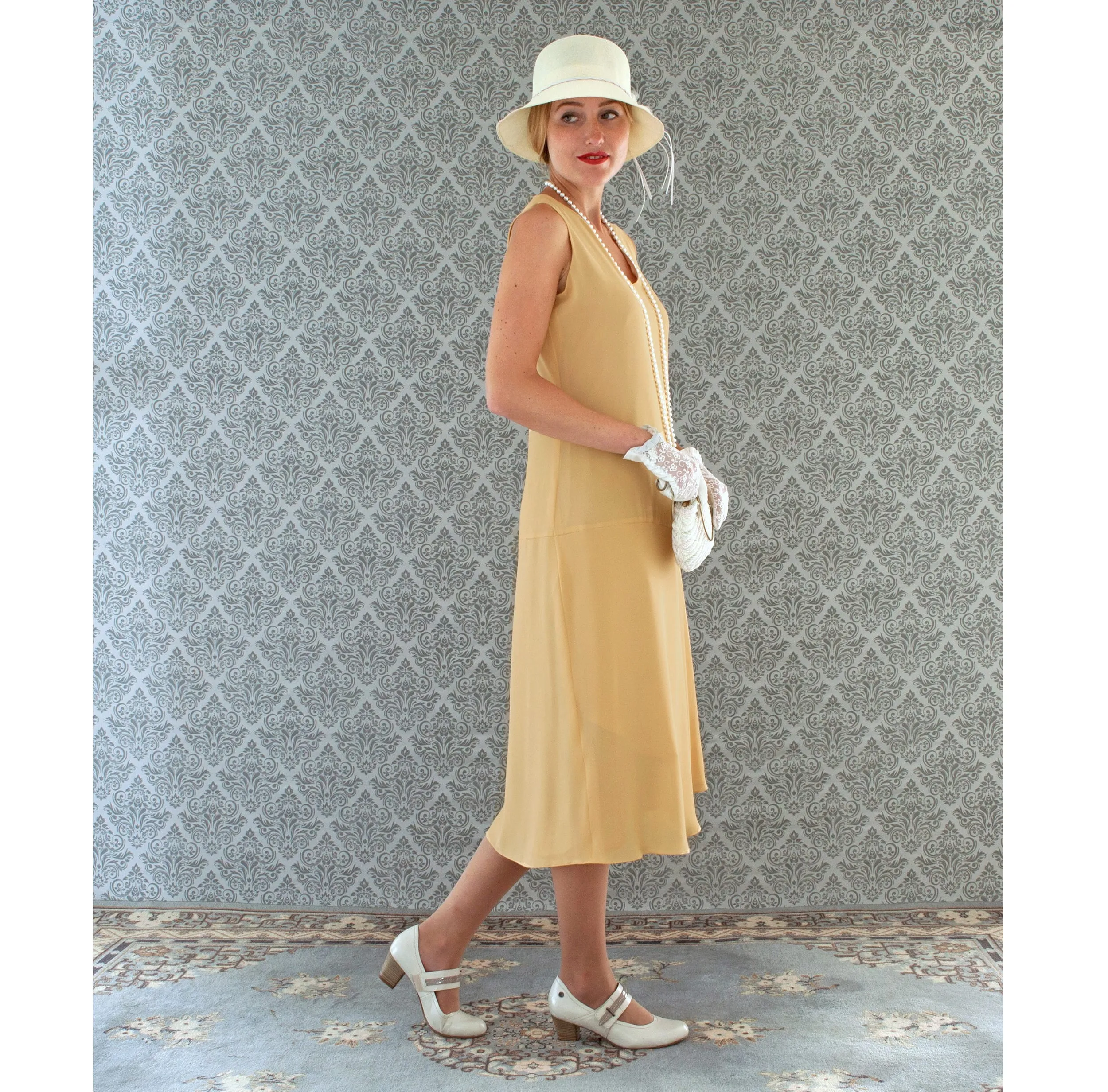 1920s-inspired flapper dress in pale marigold with drape and bow