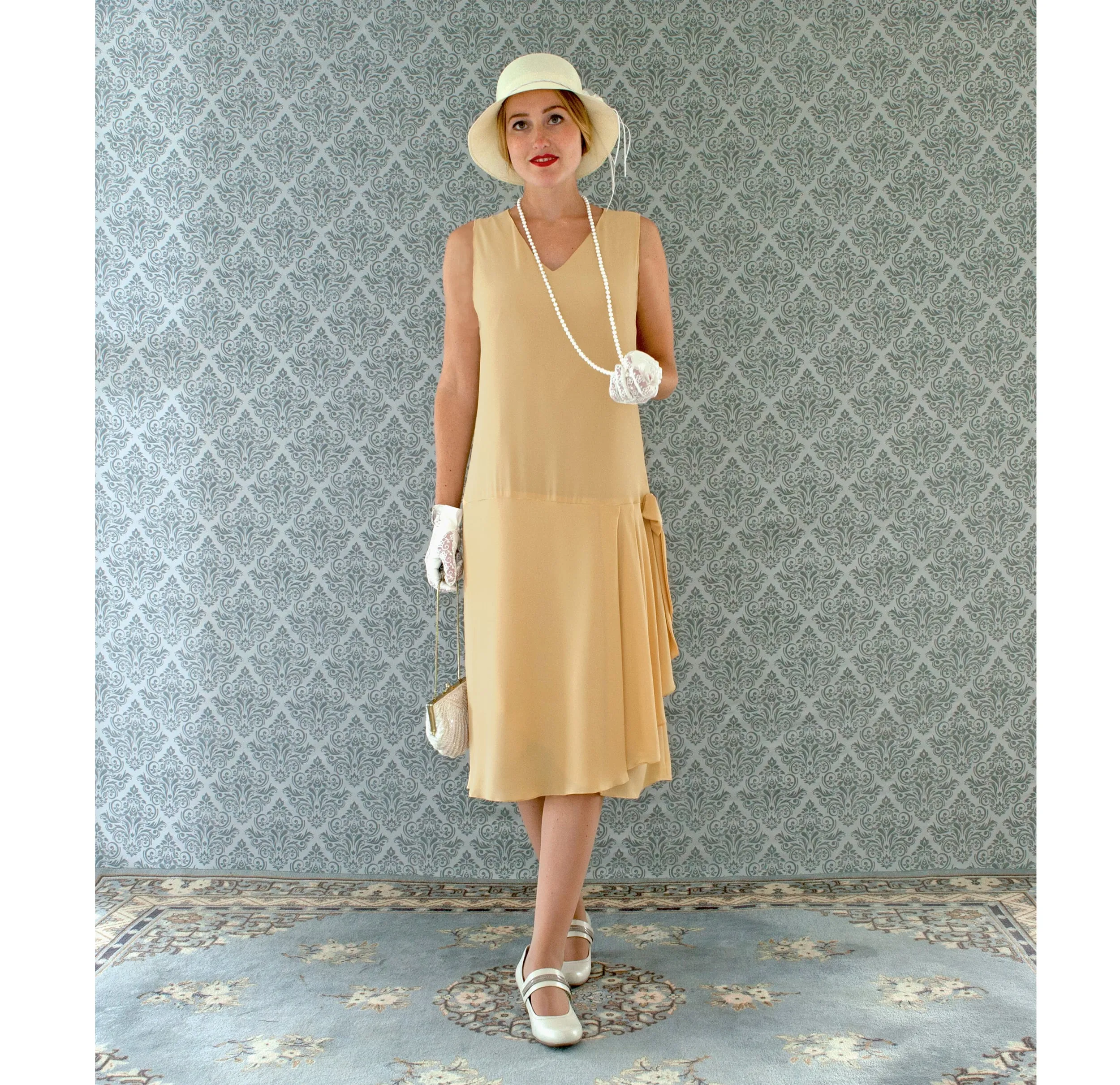 1920s-inspired flapper dress in pale marigold with drape and bow