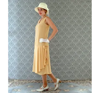 1920s-inspired flapper dress in pale marigold with drape and bow