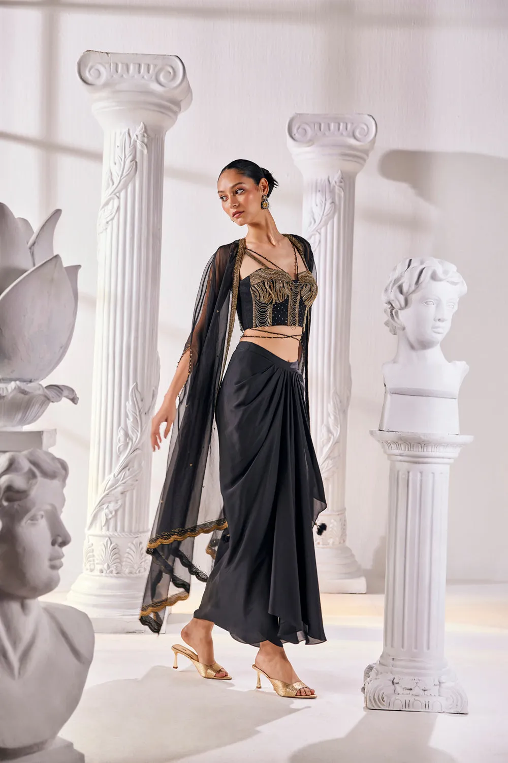 Draped Skirt Paired With An Embroidered Corset Blouse, Cape And A Belt.